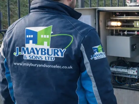 J Maybury jacket at an open electrical control panel